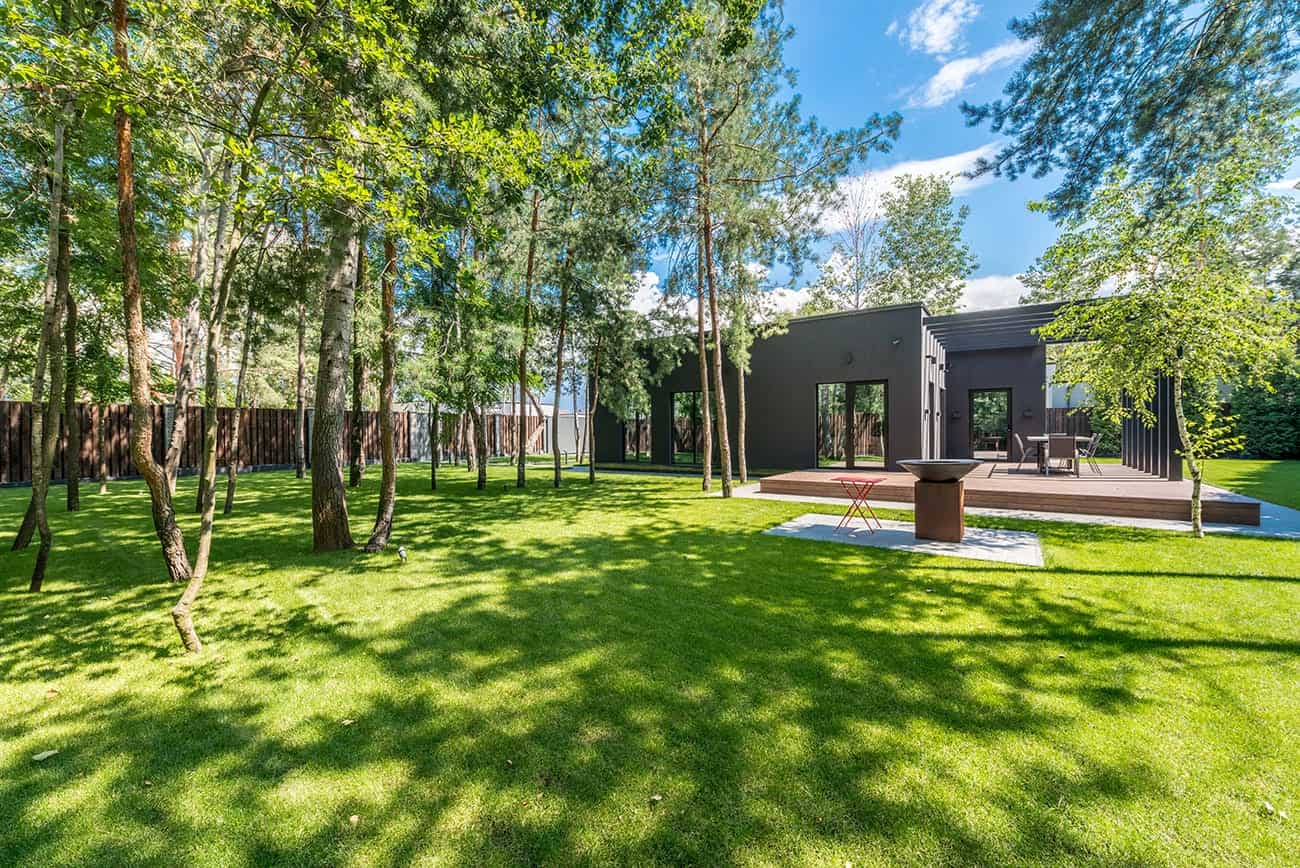 Lush green artificial grass installed in a front yard of a modern home in Olathe — low-maintenance residential turf by Artificial Grass Olathe